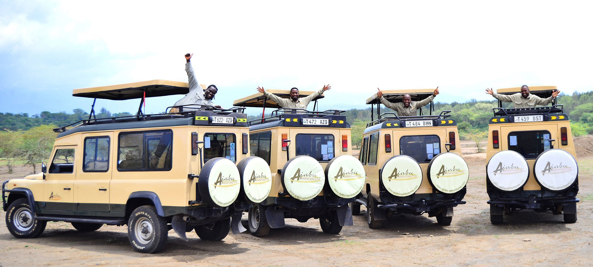 Our Ajabu Adventures safari vehicles with the local guides 