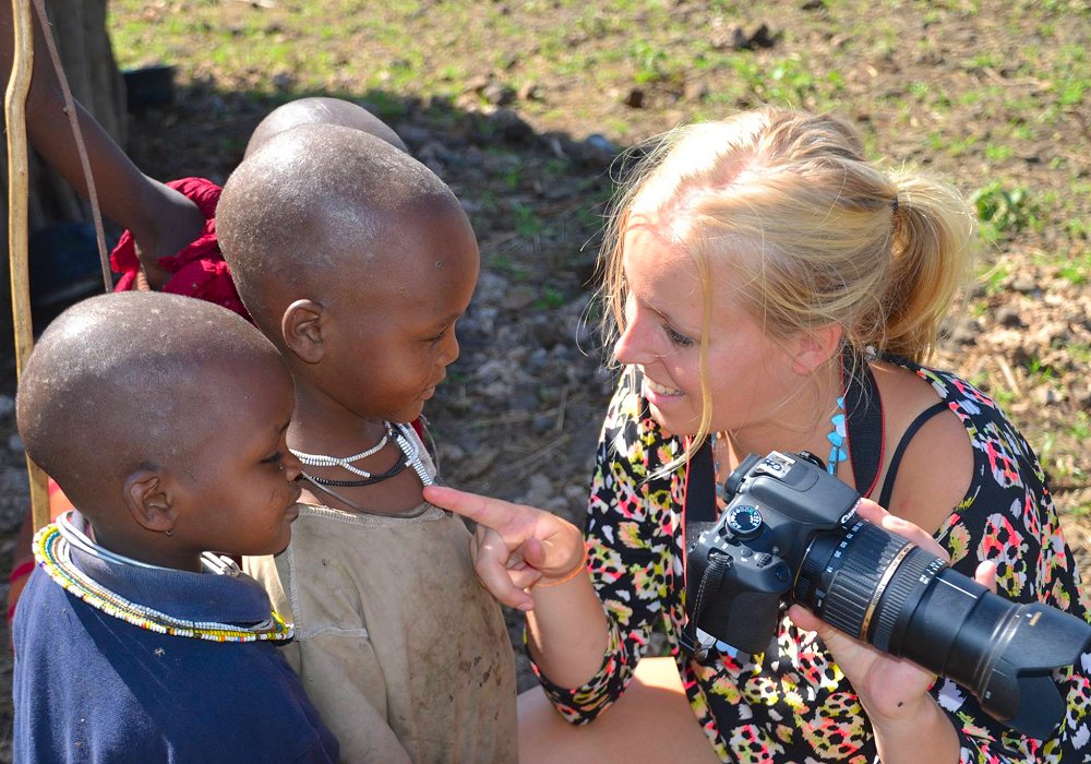 Traveller showing Maasai children photo during Tanzania safari